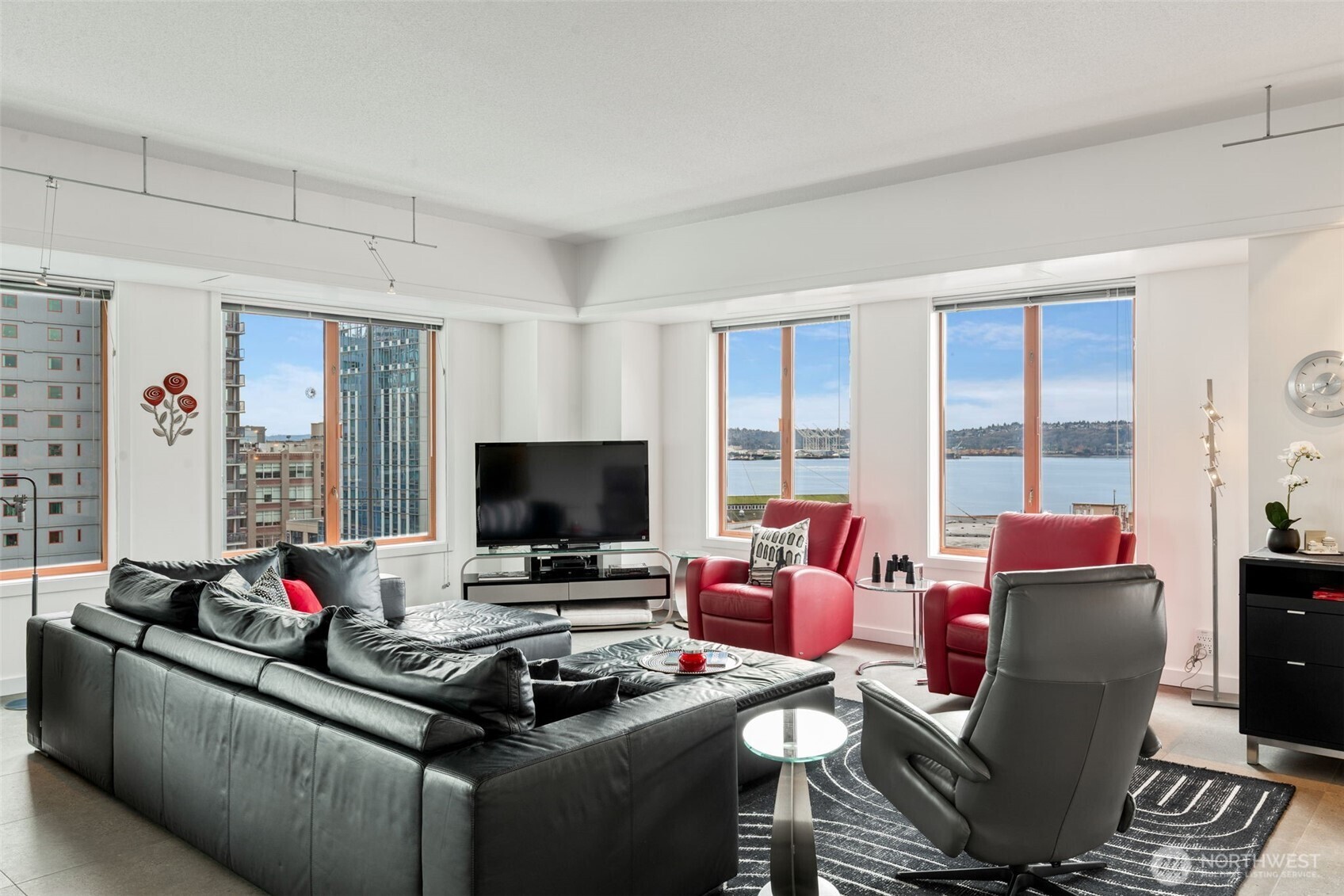 98 Union Street, Unit 206 Seattle, WA 98101 - Photo 4 of 35 a living room with furniture and a flat screen tv