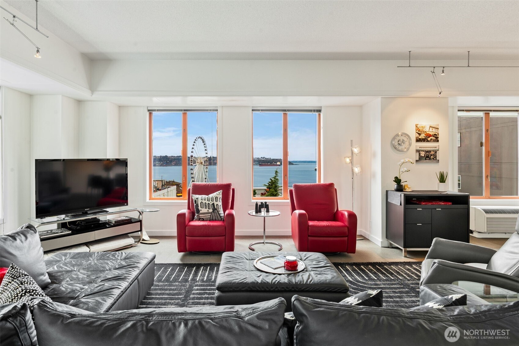 98 Union Street, Unit 206 Seattle, WA 98101 - Photo 5 of 35 a living room with furniture and a flat screen tv