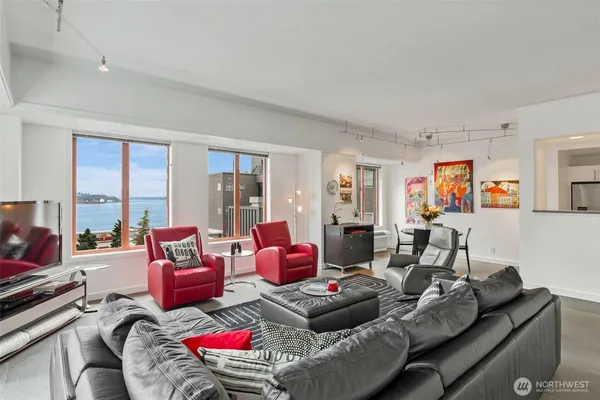 a living room with furniture and a floor to ceiling window
