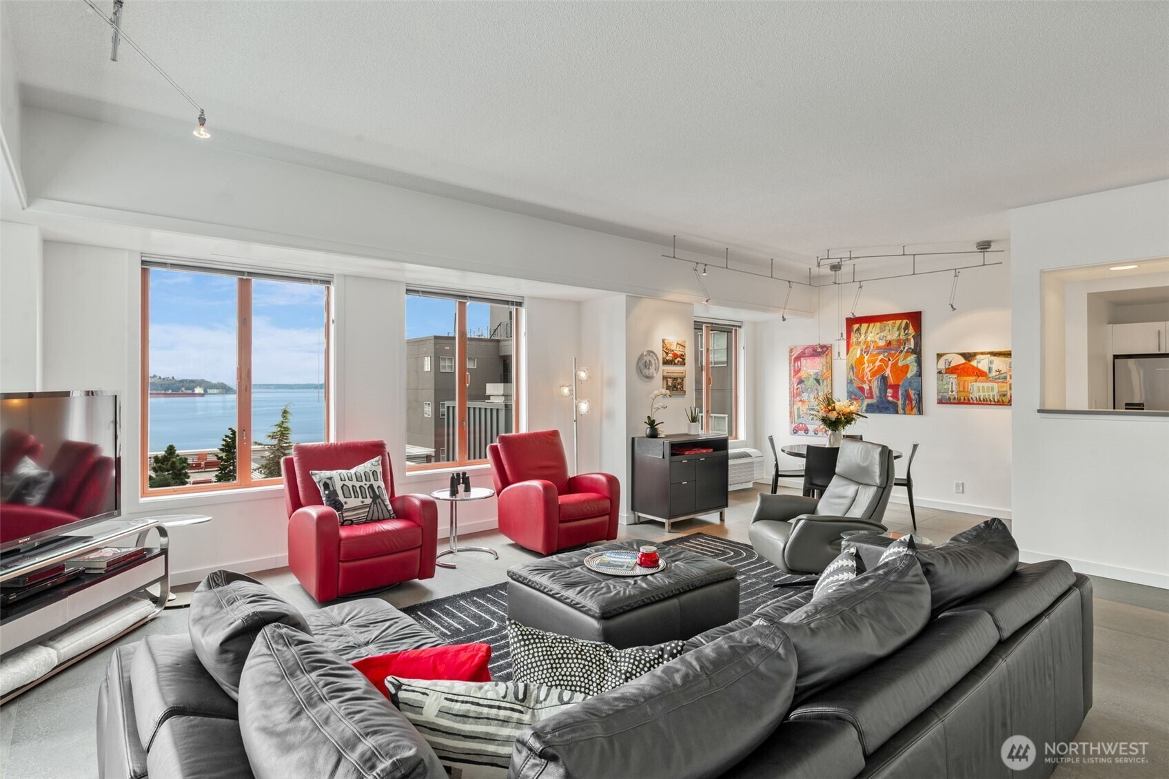 98 Union Street, Unit 206 Seattle, WA 98101 - Photo 6 of 35 a living room with furniture and a floor to ceiling window