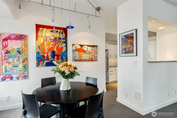 a dining room with furniture and wooden floor