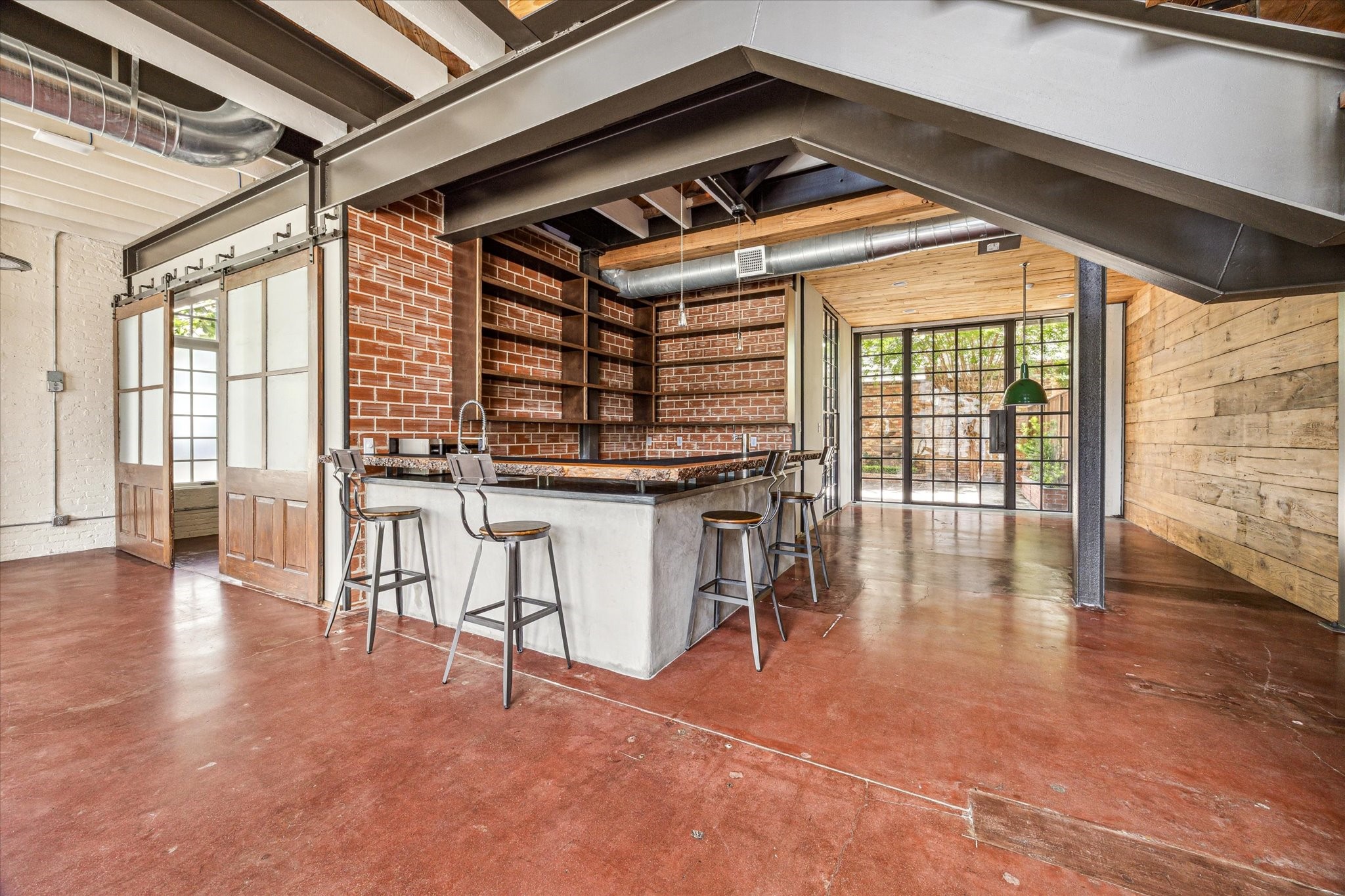 808 Coronado Street Houston, TX 77009 - Photo 9 of 50 Unit 1, Open wet bar with island seating, floating shelves, and exposed beam ceiling.