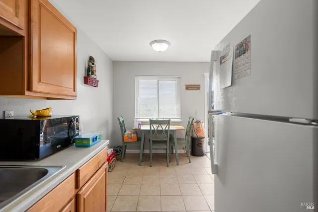 a dining room with furniture and a window