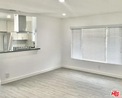 a view of a kitchen with a sink and a window