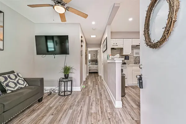 a living room with furniture and a wooden floor
