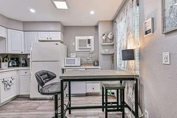 a view of a kitchen area with furniture and wooden floor