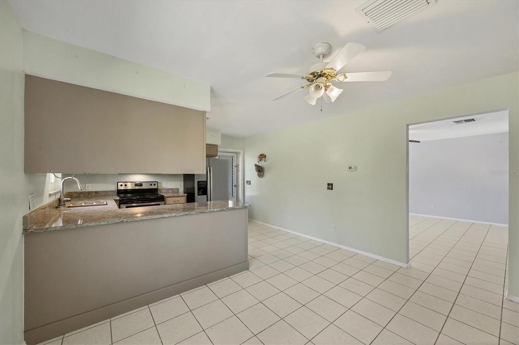 1135 Range Road Englewood, FL 34224 - Photo 17 of 42 a kitchen with stainless steel appliances a stove a refrigerator a sink and dishwasher