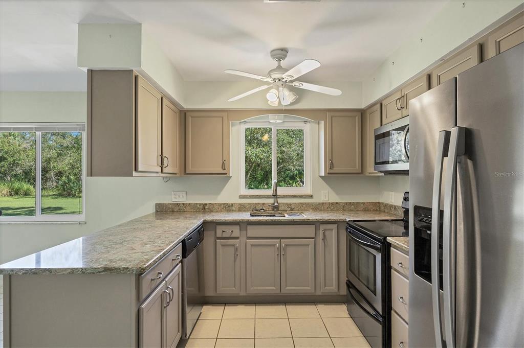 1135 Range Road Englewood, FL 34224 - Photo 20 of 42 a kitchen with a sink stove and refrigerator