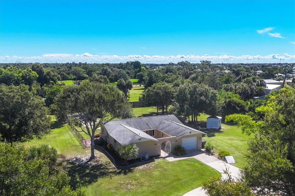 1135 Range Road Englewood, FL 34224 - Photo 2 of 42 an aerial view of a house with a yard