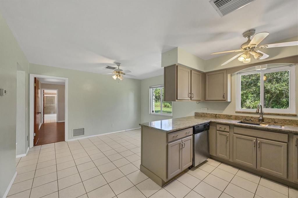 1135 Range Road Englewood, FL 34224 - Photo 21 of 42 a kitchen with a sink cabinets and window