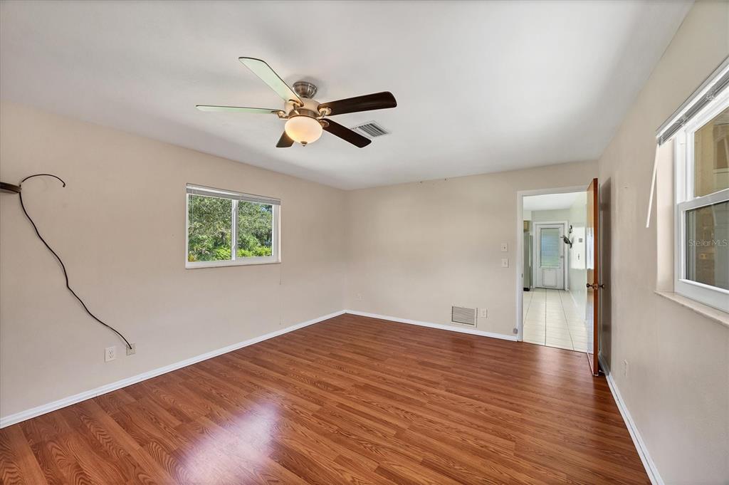 1135 Range Road Englewood, FL 34224 - Photo 25 of 42 a view of empty room with wooden floor and fan