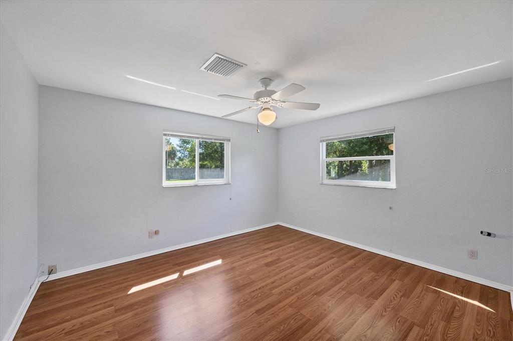 1135 Range Road Englewood, FL 34224 - Photo 28 of 42 a view of a big room with wooden floor and windows