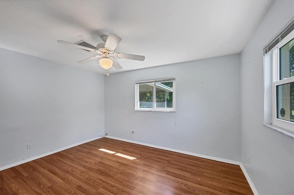 1135 Range Road Englewood, FL 34224 - Photo 29 of 42 a view of an empty room with a window and wooden floor