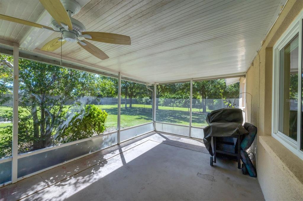 1135 Range Road Englewood, FL 34224 - Photo 32 of 42 a living room with furniture and a floor to ceiling window
