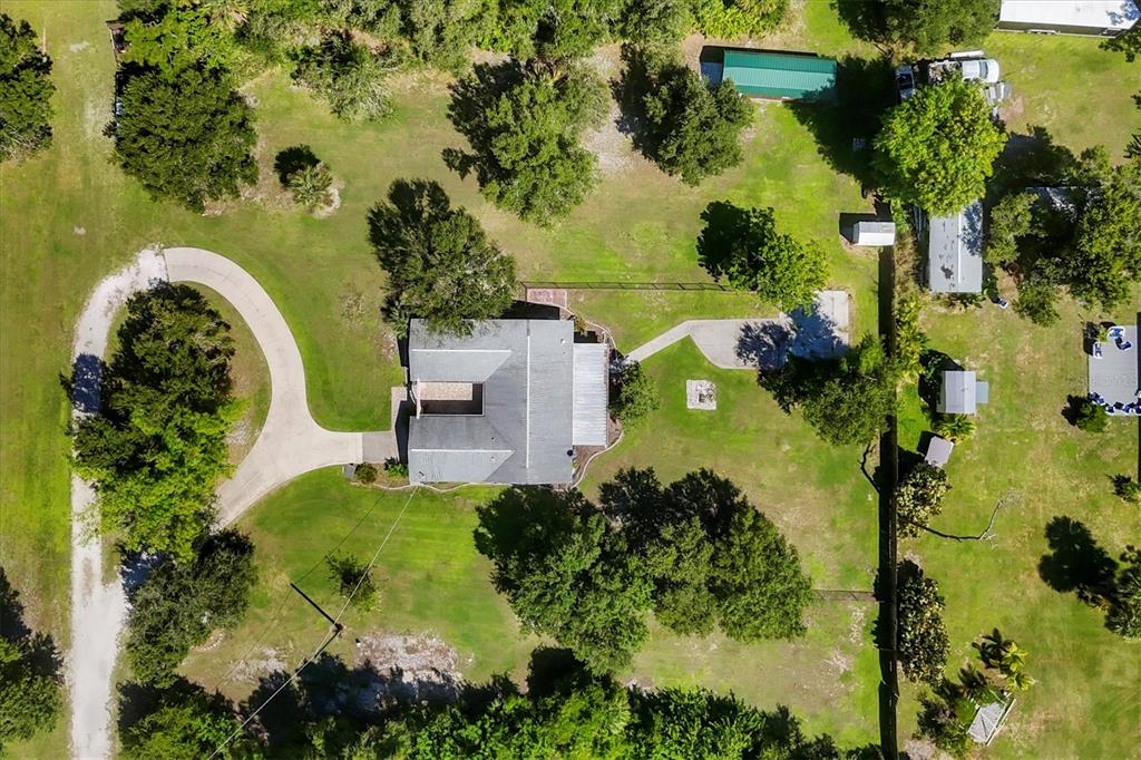 1135 Range Road Englewood, FL 34224 - Photo 4 of 42 an aerial view of a house with a yard and lake view