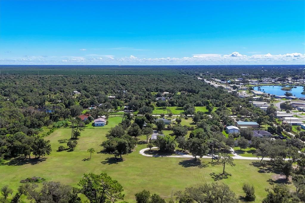 1135 Range Road Englewood, FL 34224 - Photo 5 of 42 an aerial view of residential houses with outdoor space and trees