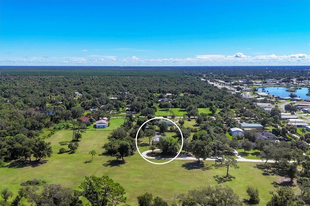 1135 Range Road Englewood, FL 34224 - Photo 6 of 42 an aerial view of a house with a yard and lake view