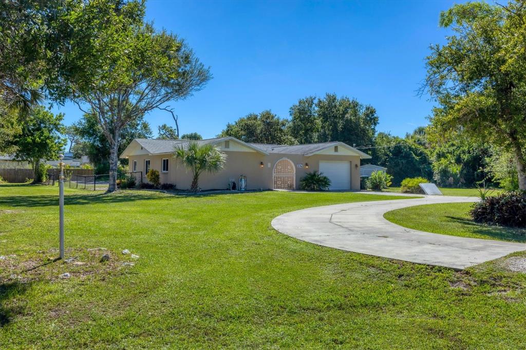 1135 Range Road Englewood, FL 34224 - Photo 9 of 42 a view of a house with a big yard