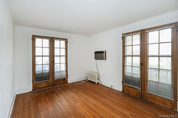 1 Ascot Ridge, Unit 1A Great Neck, NY 11021 - Photo 13 of 17 an empty room with wooden floor and windows