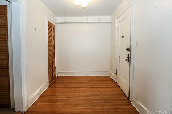 1 Ascot Ridge, Unit 1A Great Neck, NY 11021 - Photo 3 of 17 a view of a hallway with wooden floor and staircase