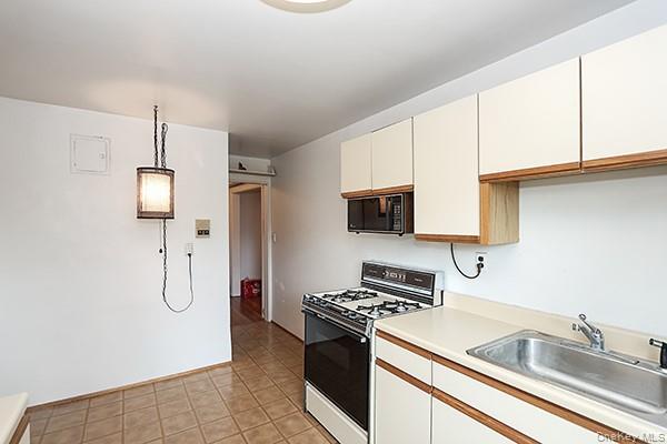 1 Ascot Ridge, Unit 1A Great Neck, NY 11021 - Photo 9 of 17 a kitchen with stainless steel appliances granite countertop a sink and a refrigerator
