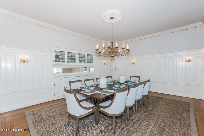 432 Field Point Road Greenwich, CT 06830 - Photo 11 of 56 a dining room with furniture a chandelier and wooden floor