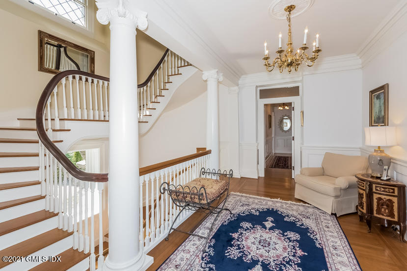 432 Field Point Road Greenwich, CT 06830 - Photo 26 of 56 a living room with furniture and a chandelier