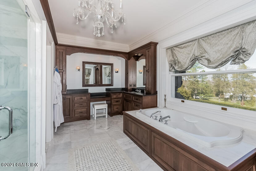 432 Field Point Road Greenwich, CT 06830 - Photo 30 of 56 a large bathroom with a double vanity sink a mirror and a bathtub