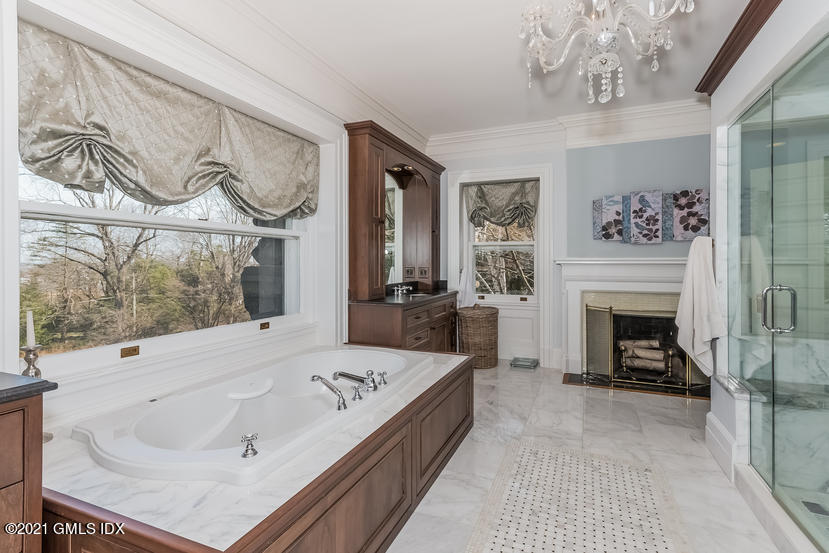 432 Field Point Road Greenwich, CT 06830 - Photo 31 of 56 a large bedroom with a bed and a fireplace