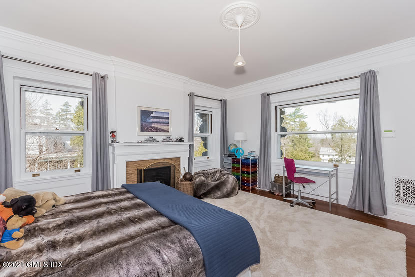 432 Field Point Road Greenwich, CT 06830 - Photo 32 of 56 a bed room with a bed and a fireplace