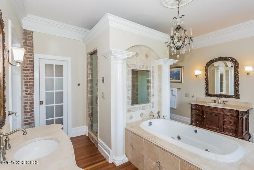432 Field Point Road Greenwich, CT 06830 - Photo 33 of 56 a spacious bathroom with a tub sink shower and mirror