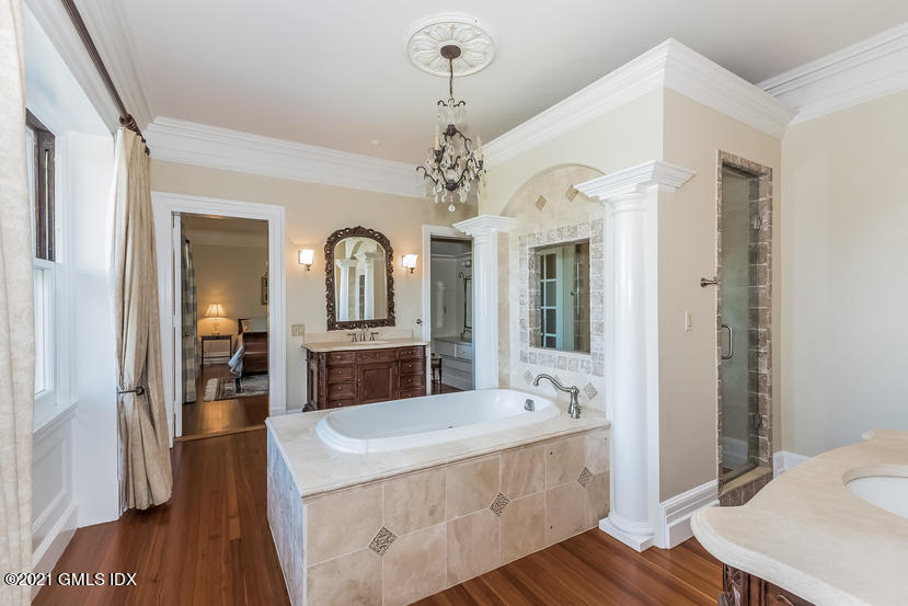 432 Field Point Road Greenwich, CT 06830 - Photo 34 of 56 a large spacious bathroom with a double vanity sink and a mirror