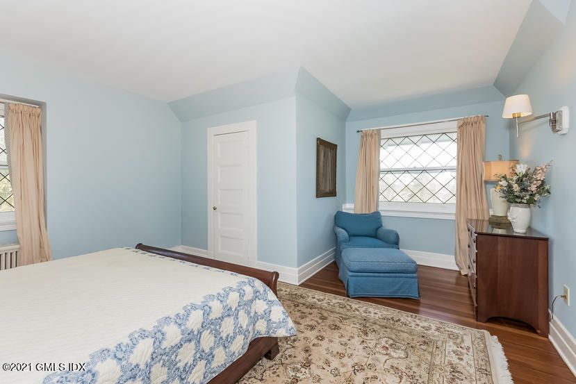 432 Field Point Road Greenwich, CT 06830 - Photo 38 of 56 a bedroom with a bed and wooden floor