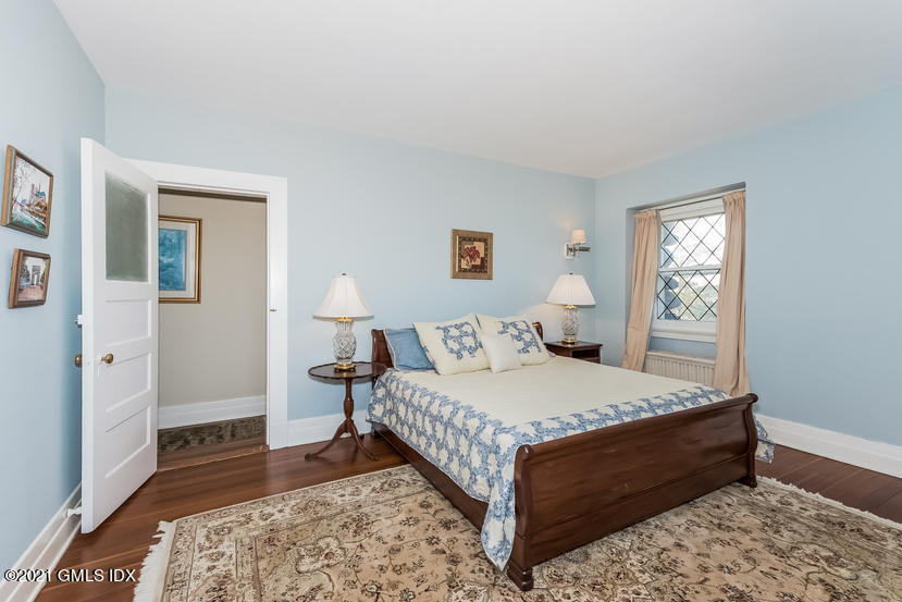 432 Field Point Road Greenwich, CT 06830 - Photo 39 of 56 a bedroom with a bed and wooden floor