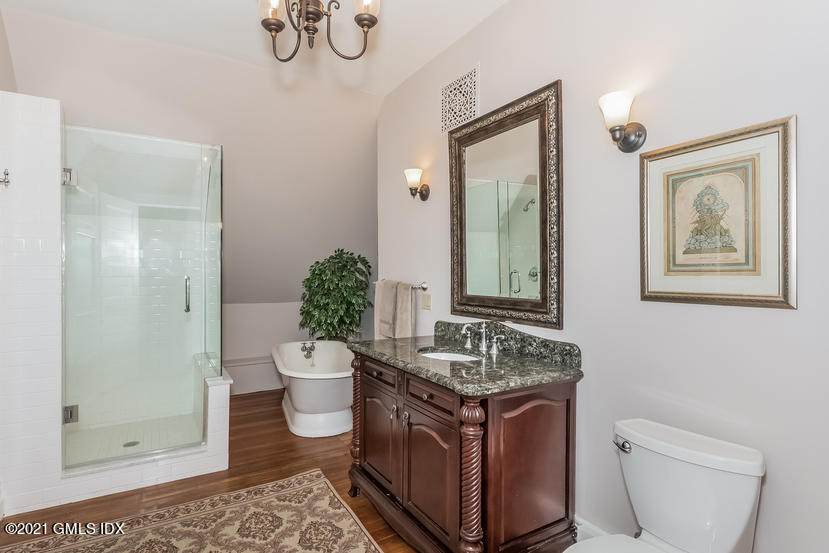 432 Field Point Road Greenwich, CT 06830 - Photo 41 of 56 a bathroom with a granite countertop sink toilet and mirror