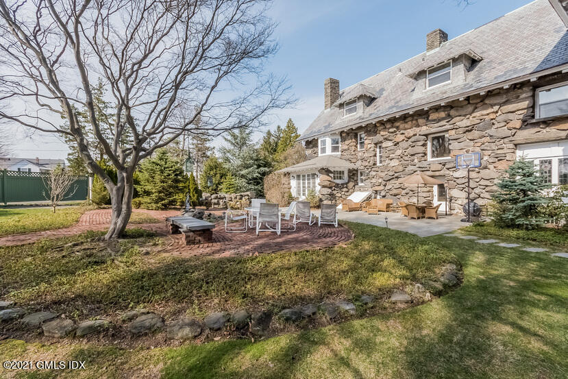 432 Field Point Road Greenwich, CT 06830 - Photo 54 of 56 a view of a large yard with plants and large trees