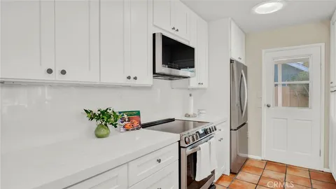 a kitchen with stainless steel appliances white cabinets and a stove