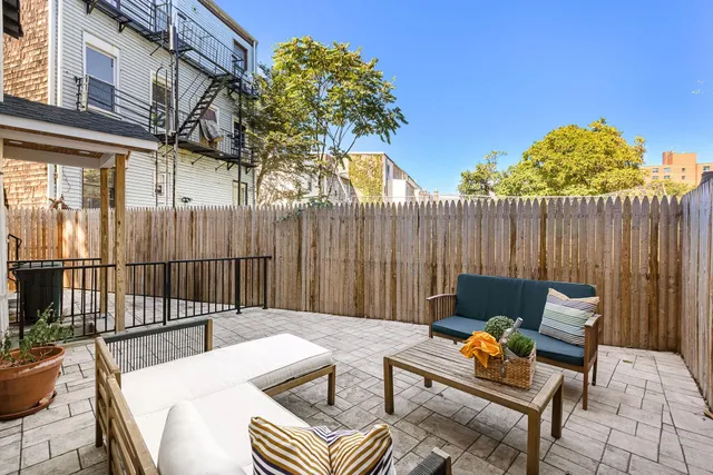 a backyard of a house with table and chairs