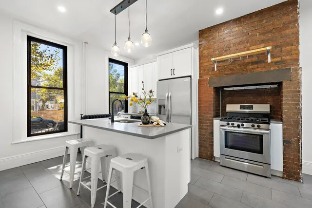 a kitchen with stainless steel appliances granite countertop a stove and a refrigerator