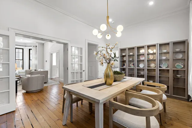 a view of a dining room with furniture wooden floor and chandelier