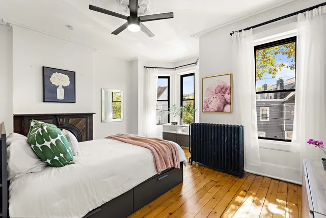 a bedroom with a bed and a window