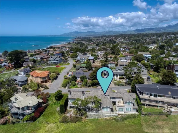 an aerial view of a house with a swimming pool yard and mountain view in back