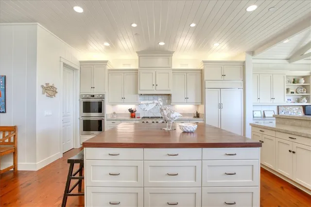 a bathroom with a granite countertop sink and a large window