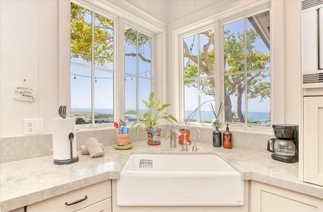 a view of a balcony with chairs and potted plants