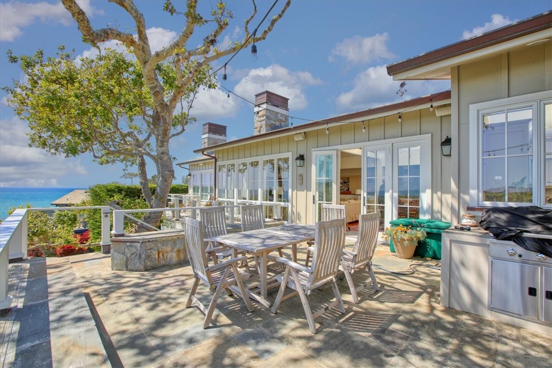404 Huntington Road Cambria, CA 93428 - Photo 27 of 72 a view of a patio with table and chairs and potted plants
