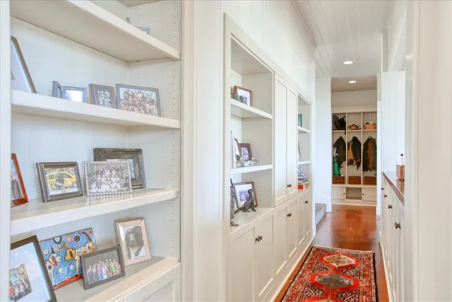 a view of a balcony with wooden floor and iron fence
