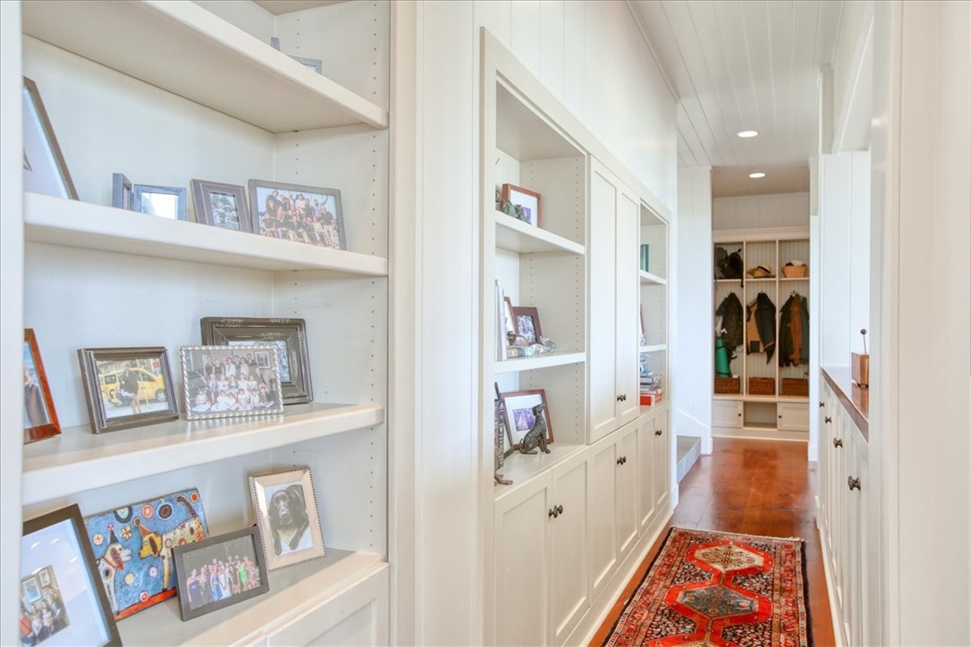 404 Huntington Road Cambria, CA 93428 - Photo 35 of 72 a hallway with painting on the wall and paintings on the wall