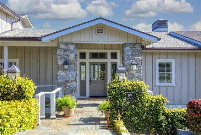 a living room with furniture large window and a fireplace