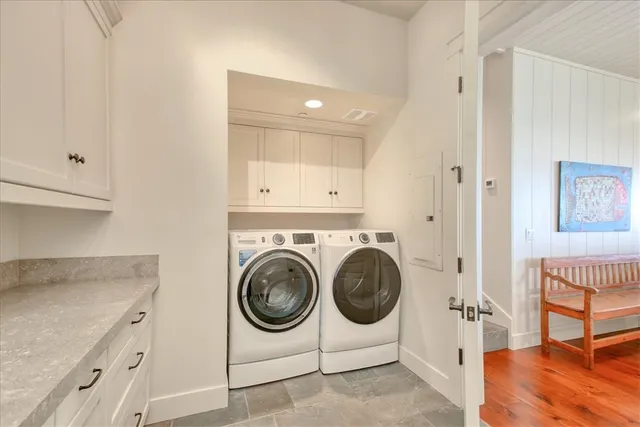 a living room with fireplace furniture and a large window