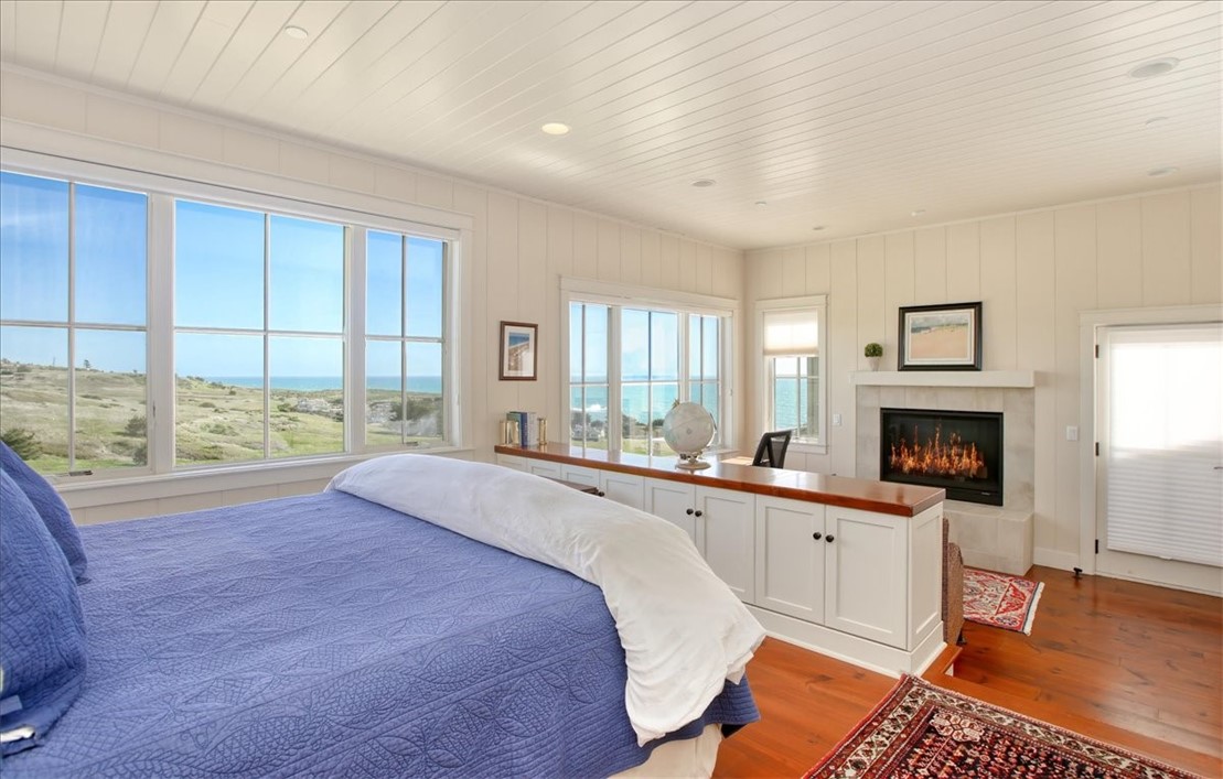 404 Huntington Road Cambria, CA 93428 - Photo 45 of 72 a spacious bedroom with a large bed and a window